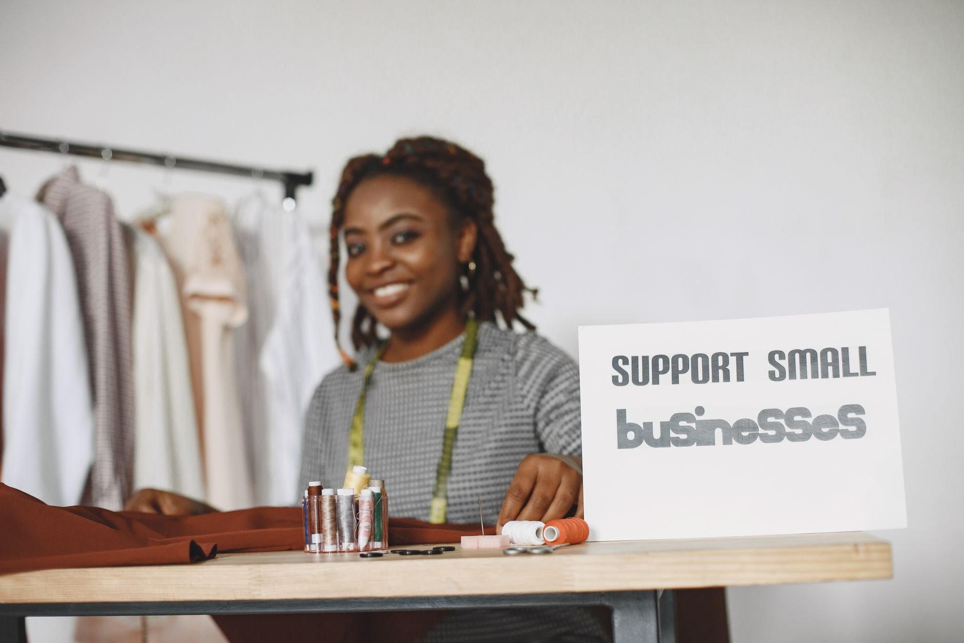 Small business owner smiling while managing customer enquiries